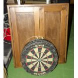 Two dartboards together with a dartboard cabinet