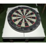 Two dartboards together with a dartboard cabinet