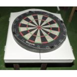 Two dartboards together with a dartboard cabinet