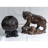 A wood carved tiger figure together with a bowl with carved wood elephants to the base