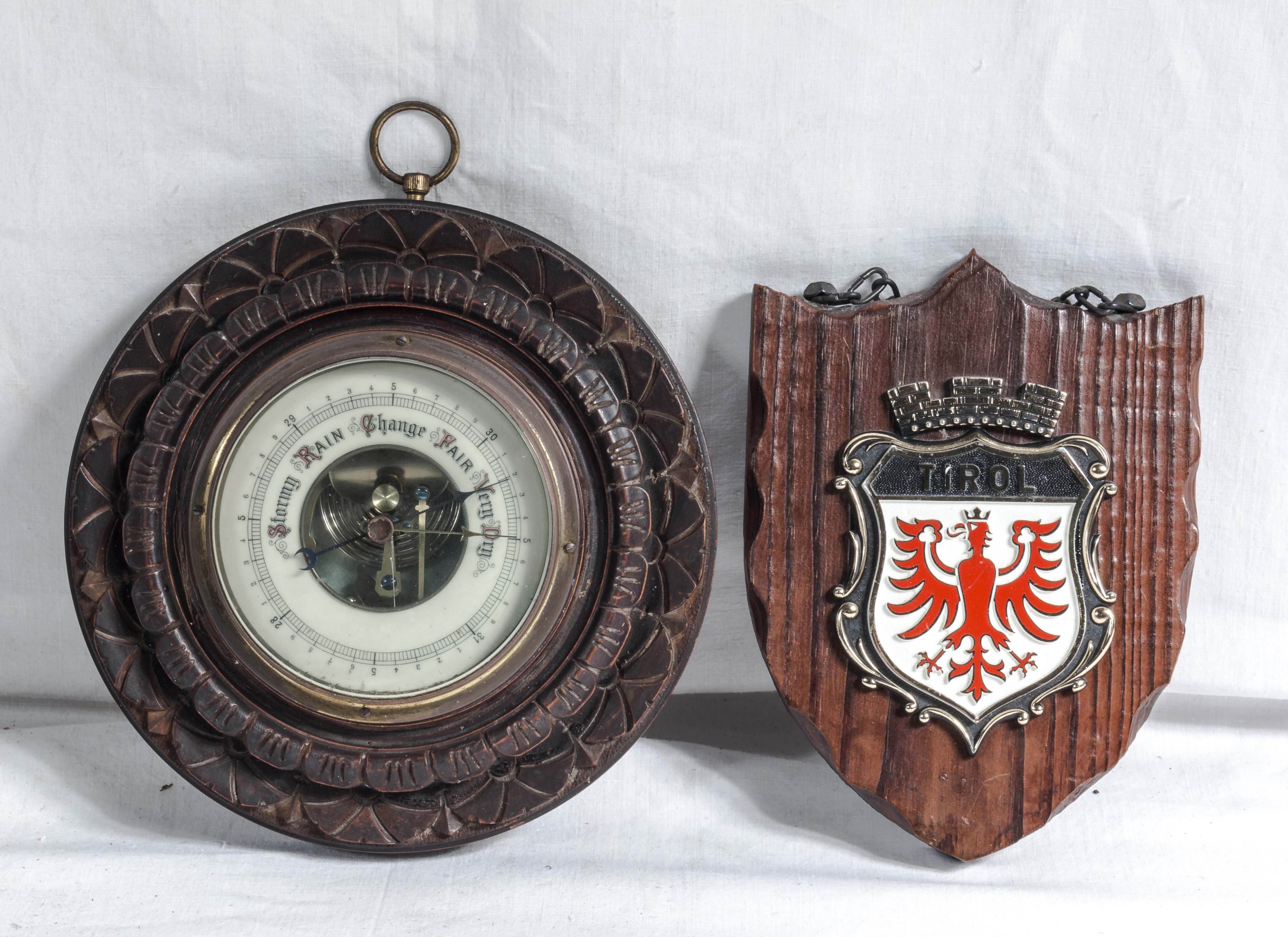 A barometer and a wall hanging plaque