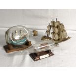 A model Spanish galleon in a bottle, model H.M.S Victory in a bottle and one other made from sea