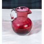 A cranberry glass jug