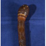 A carved bamboo walking cane