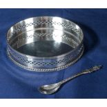 A silver plated bottle coaster and a spoon