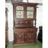 A Continental carved oak bookcase on cupboards