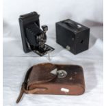 A vintage Kodak bellows camera with leather case together with a Kodak box camera