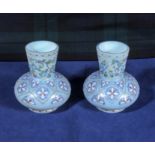 A pair of Victorian blue overlay glass and decorated vases