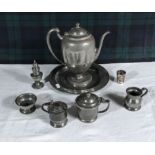 A pewter coffee pot, plate, condiments and other items