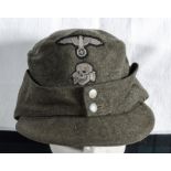 A WWII German Waffen SS M43 ski cap with herring bone lining, two piece early Bevo insignia.