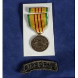 An American Vietnam service medal with pendant service ribbon, clip and bar. Airborne shoulder