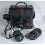 A Canon EOS IX7 camera with lens in carrying case