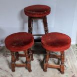 Twelve small bar stools and one tall stool