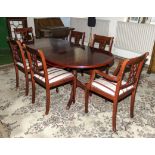 A reproduction extending dining table with two carvers and four chairs