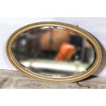 An oval gilt framed mirror