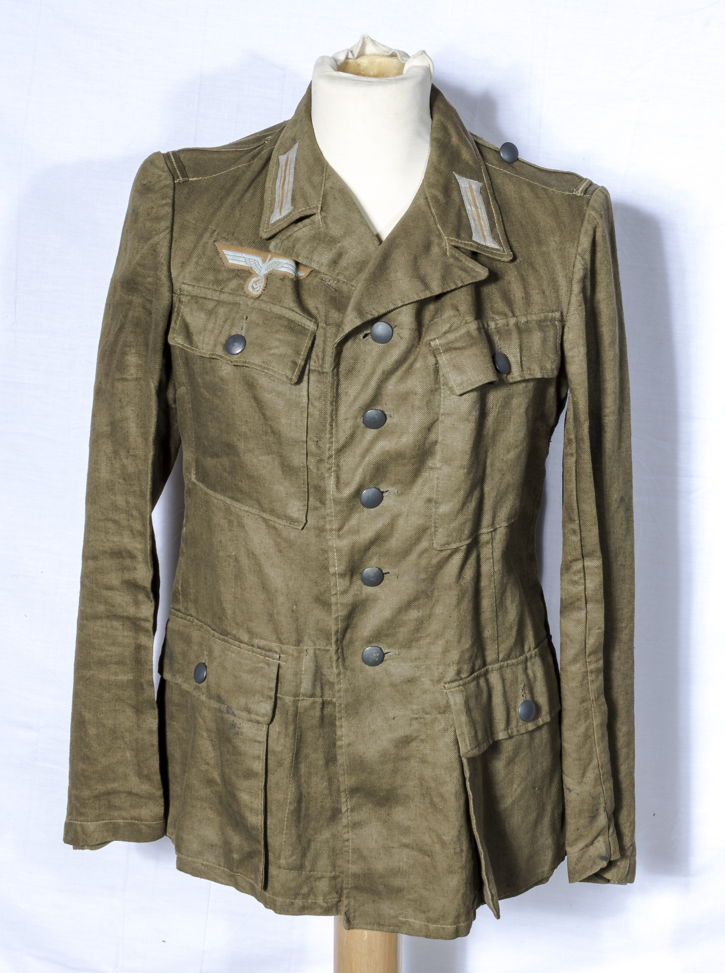 A WWII German tropical tunic, date and size stamps to inside lining