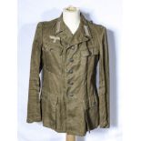 A WWII German tropical tunic, date and size stamps to inside lining