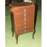 A mahogany six drawer music cabinet
