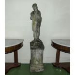 A reconstituted stone figure of a lady on a plinth