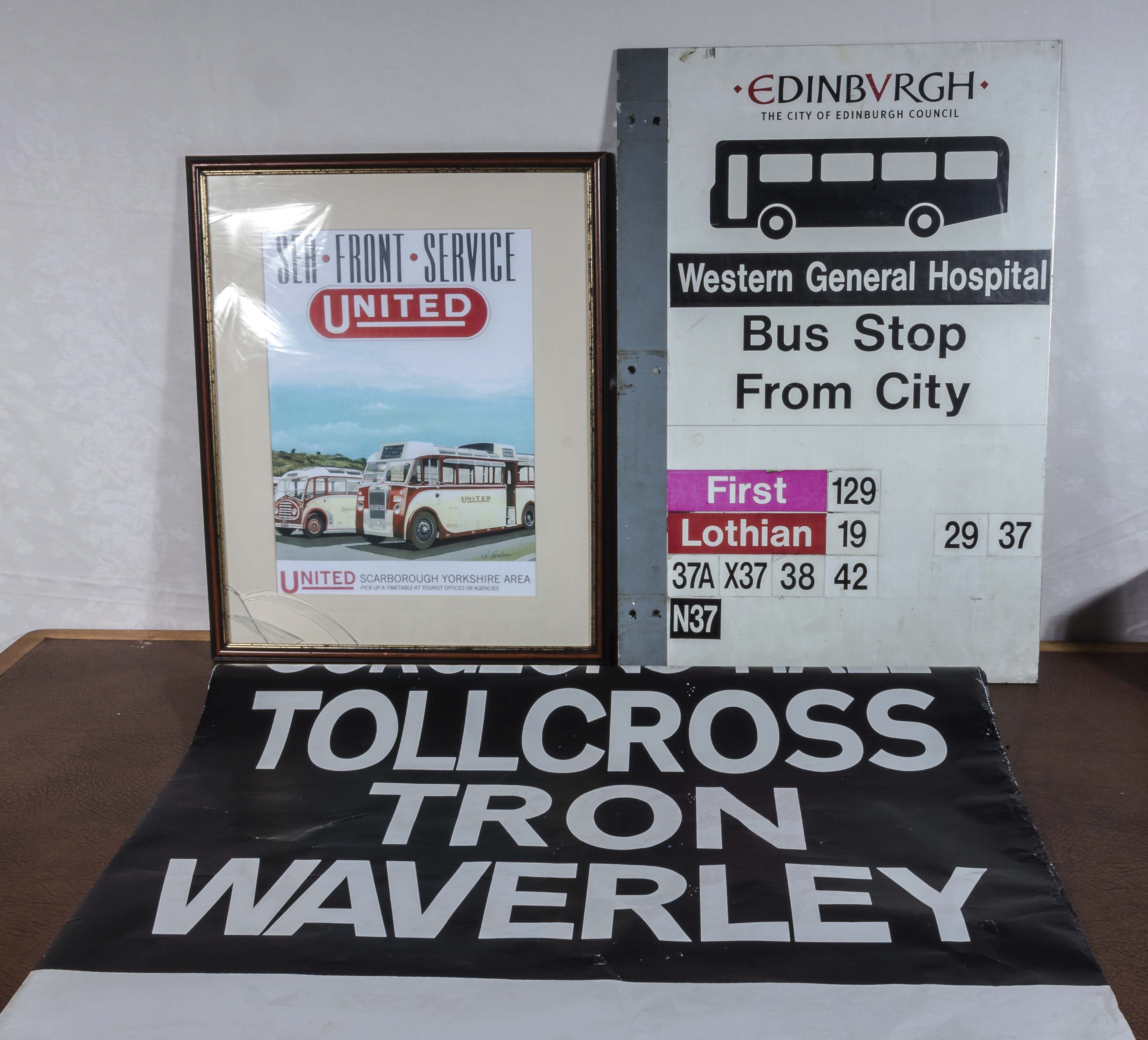 A destination roll for a bus, a metal Edinburgh bus stop sign and a framed United Bus poster