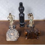 A pair of book ends, a carved wood figure and three other ornamental figures