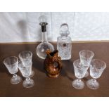 Two decanters, six wine glasses and a gurgle jug