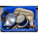 A box containing Le Crueset pots and other kitchen items