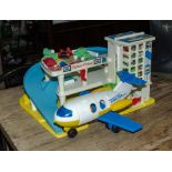 A Fisher Price toy garage and aeroplane