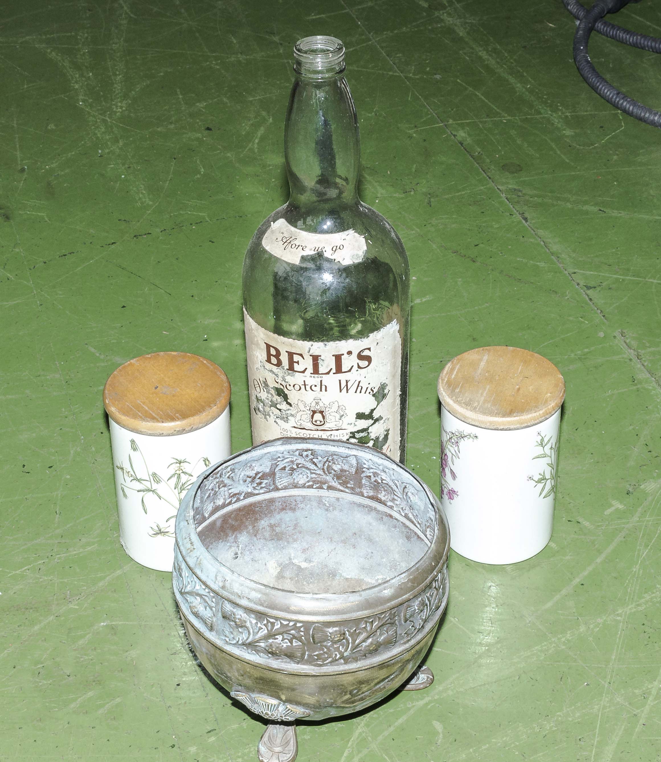A large Bell's whisky bottle, brass planter and two kitchen jars