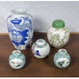 Four Oriental style ginger jars and a vase