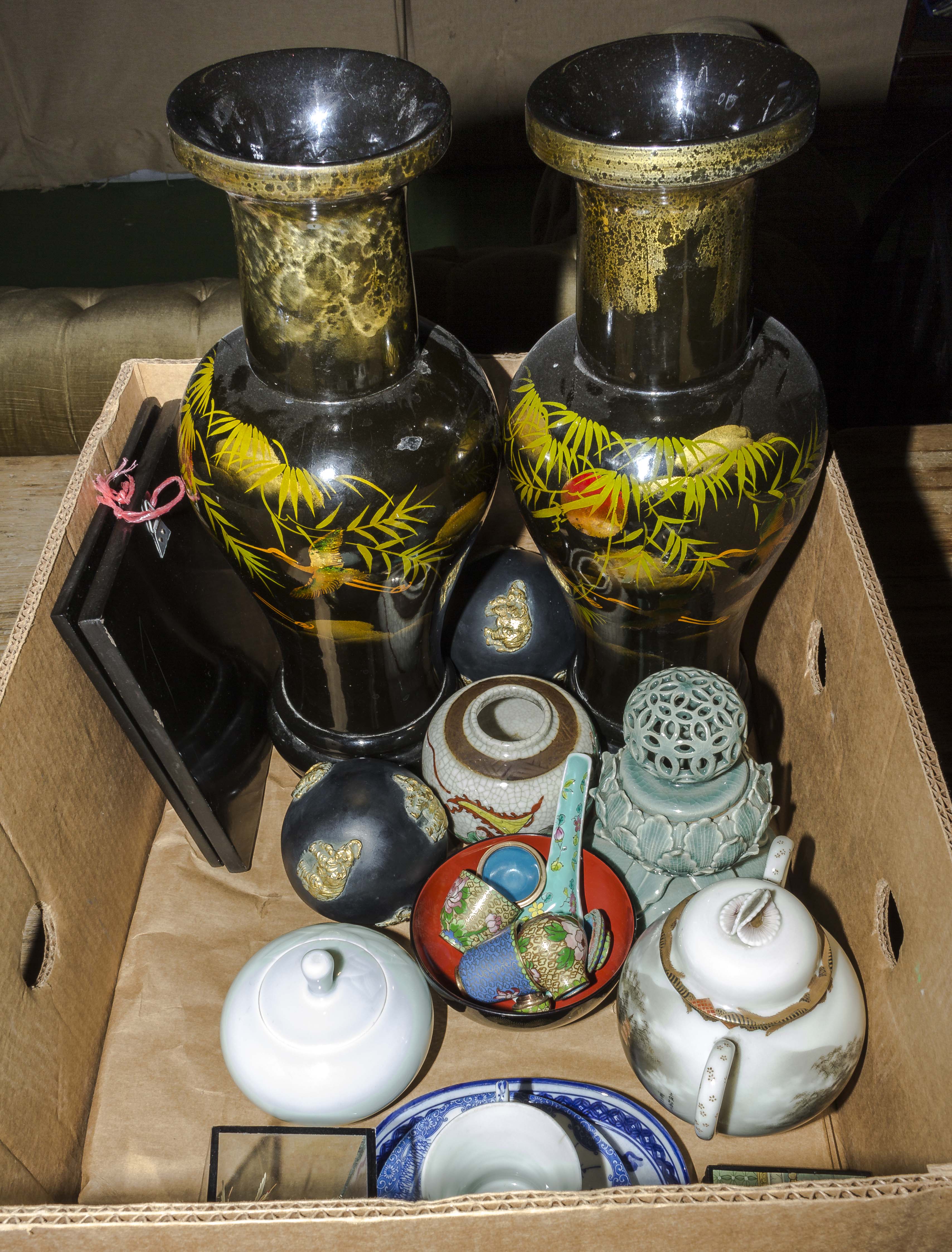 A box containing ornamental vases and other items