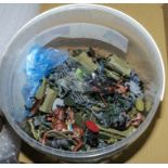 A bucket containing toy soldiers and other small toys