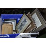 A box of framed prints