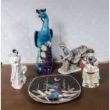 Four Oriental style figures and a plate