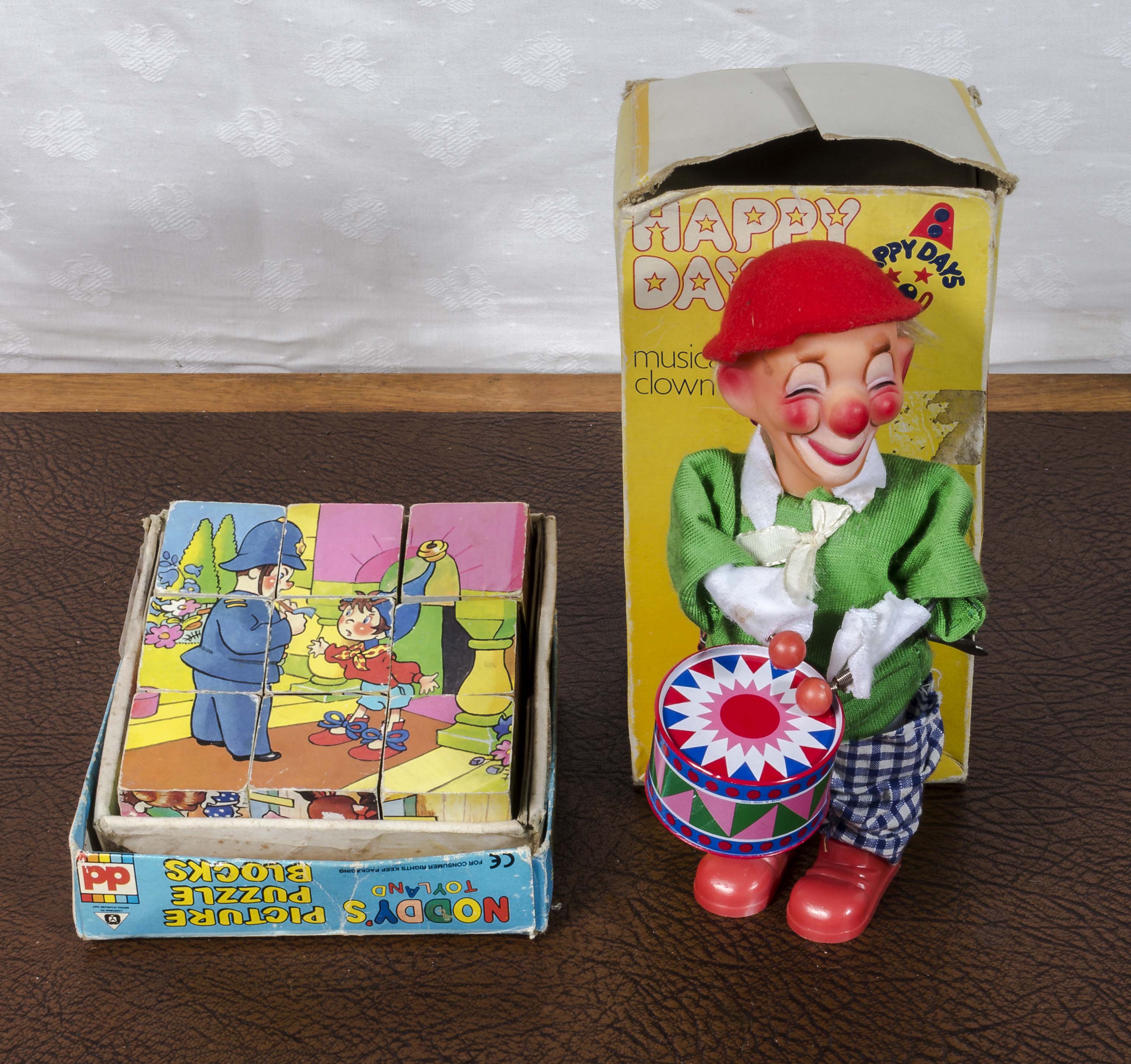 A vintage block jigsaw puzzle and a vintage Happy Days musical clown