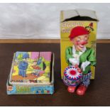 A vintage block jigsaw puzzle and a vintage Happy Days musical clown