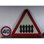 An metal railway crossing road sign together with a 40 limit sign