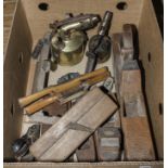 A box containing vintage planes and two brass blow torches