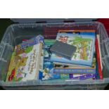 A box containing children's books and jigsaws