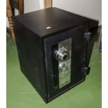 A small floor standing safe with key and combination