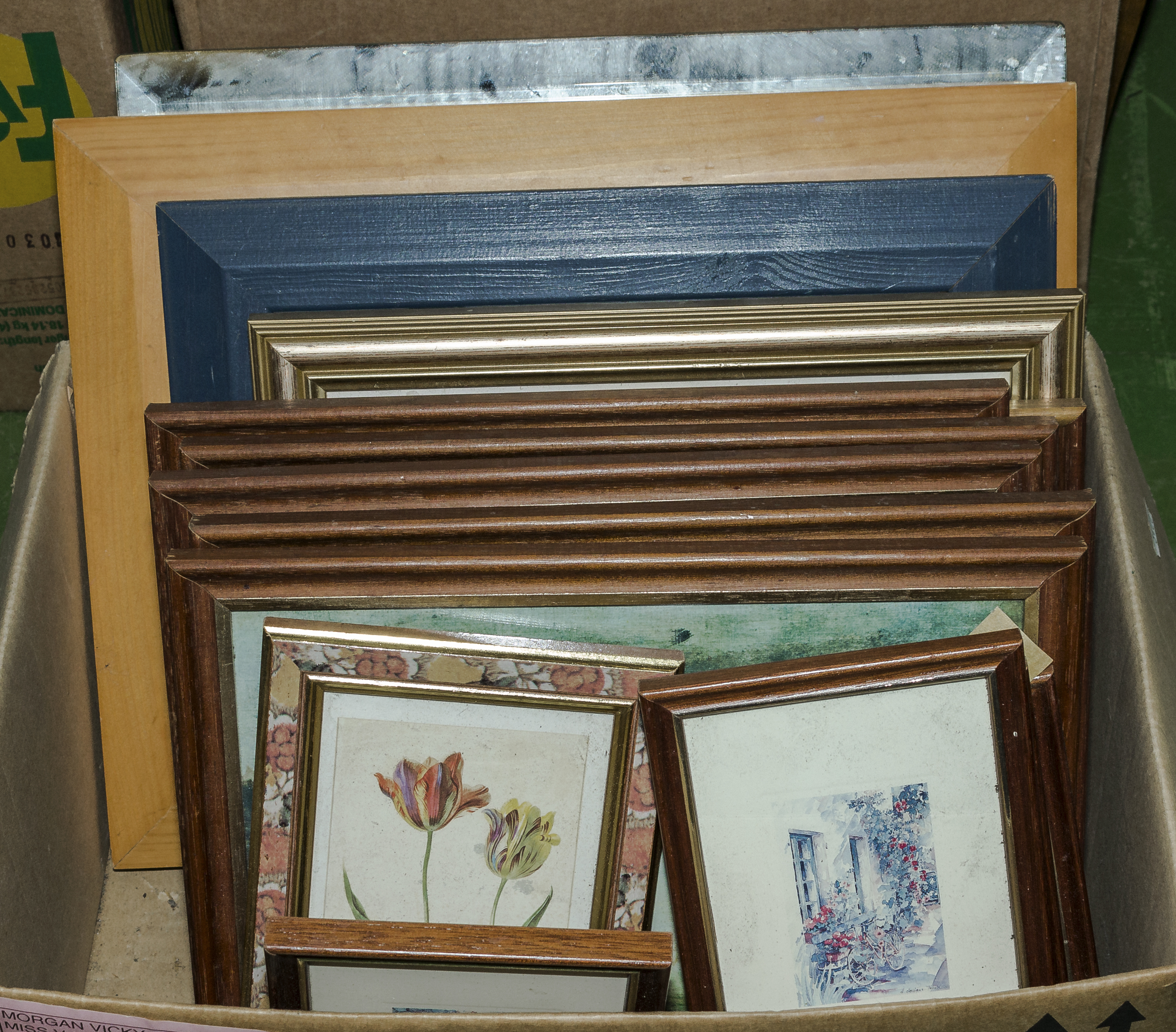 A box containing framed prints