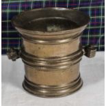 A 16th/17th century bronze mortar with hand shaped handles.