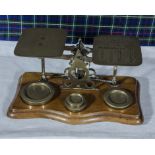 A Victorian brass postal scale with weights.