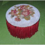 A footstool with beadwork top