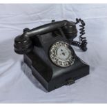 A vintage black bakelite bell telephone