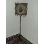 A Victorian mahogany pole screen.