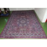 A large wool red ground carpet 4.5 x 3.1 mtrs