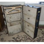 A vintage travel trunk with fitted interior