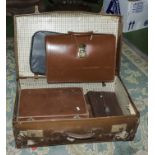 A vintage suitcase, briefcase and other leather cases