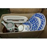 A box containing plates and other pottery items
